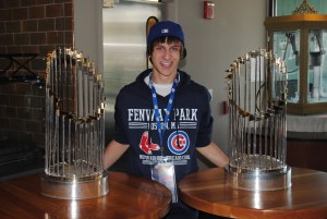 A young Cubs fan poses with the 2004 & 2007 World Series trophies